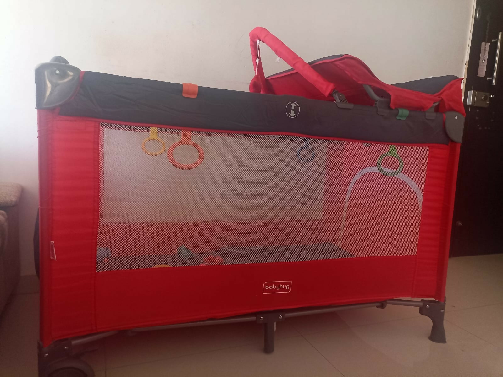 Babyhug playpen with mosquito net, helper rings, cot mobile and diaper changing table, foldable and travel-friendly, used for 7 months