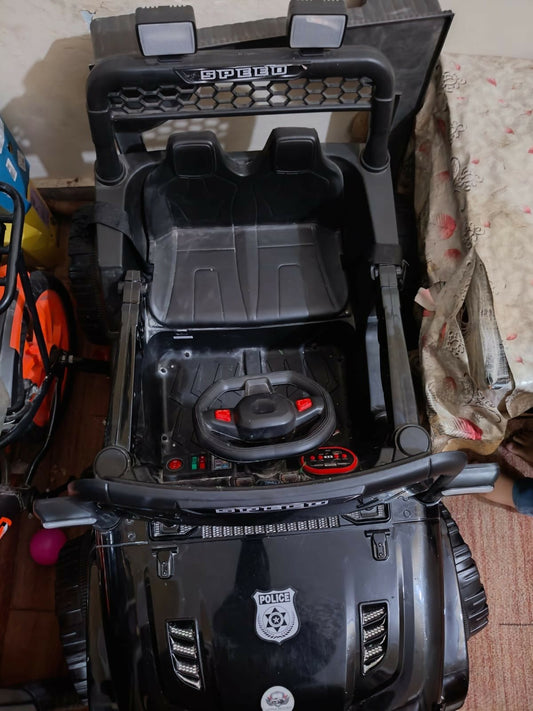 Electric car for kids with a rechargeable battery, realistic steering wheel, comfortable seat, LED lights, durable wheels, and easy controls for fun indoor and outdoor adventures.