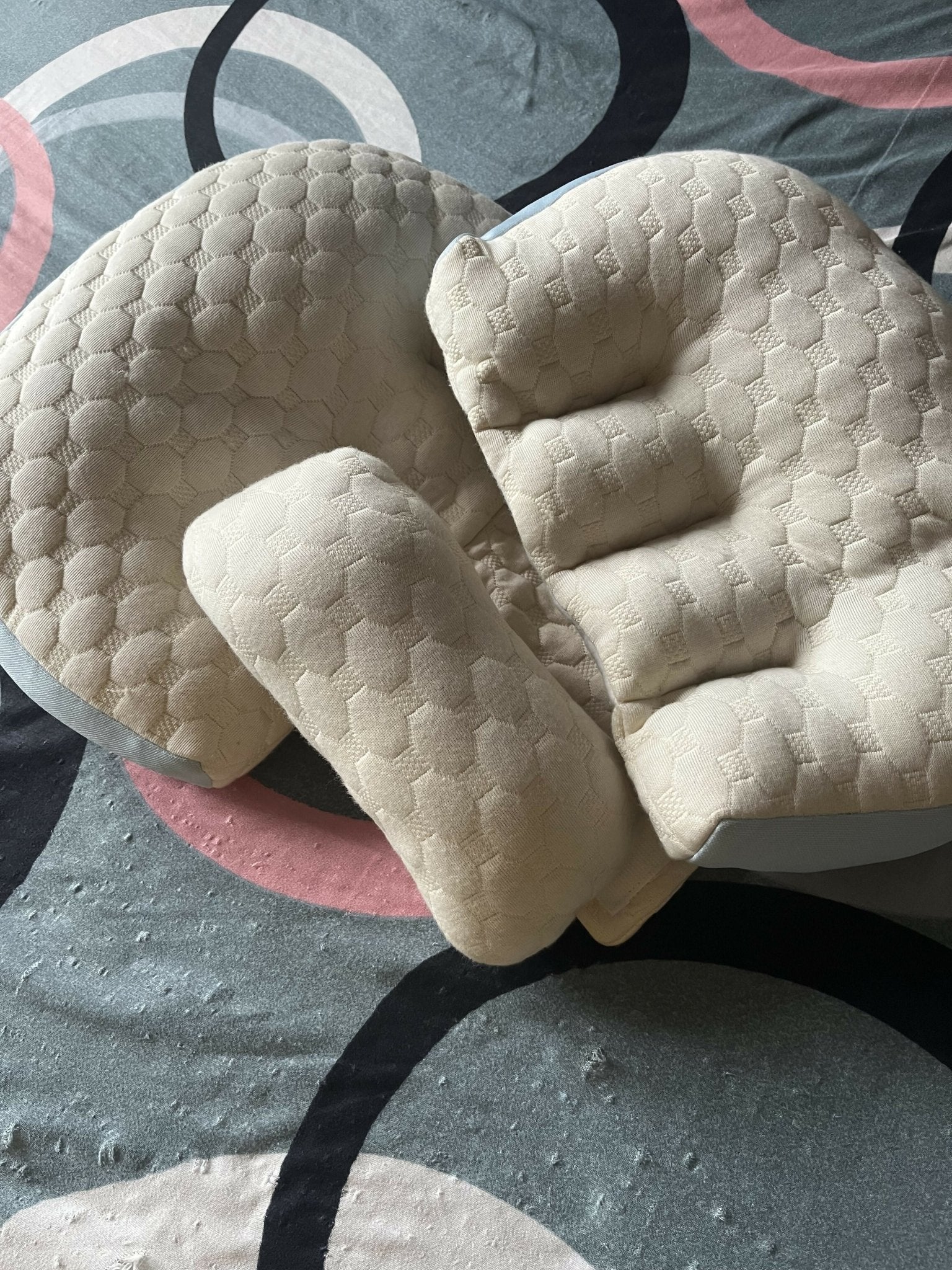 Frido maternity pillow with ergonomic full-body support, soft breathable fabric, and a comfortable design to support the back, belly, hips, and legs during pregnancy.