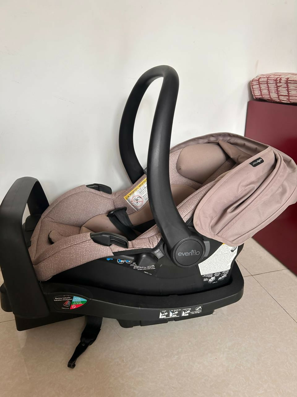 Evenflo LiteMax infant car seat with cushioned newborn support, secure safety harness, lightweight portable design, and comfortable seating for safe baby travel.
