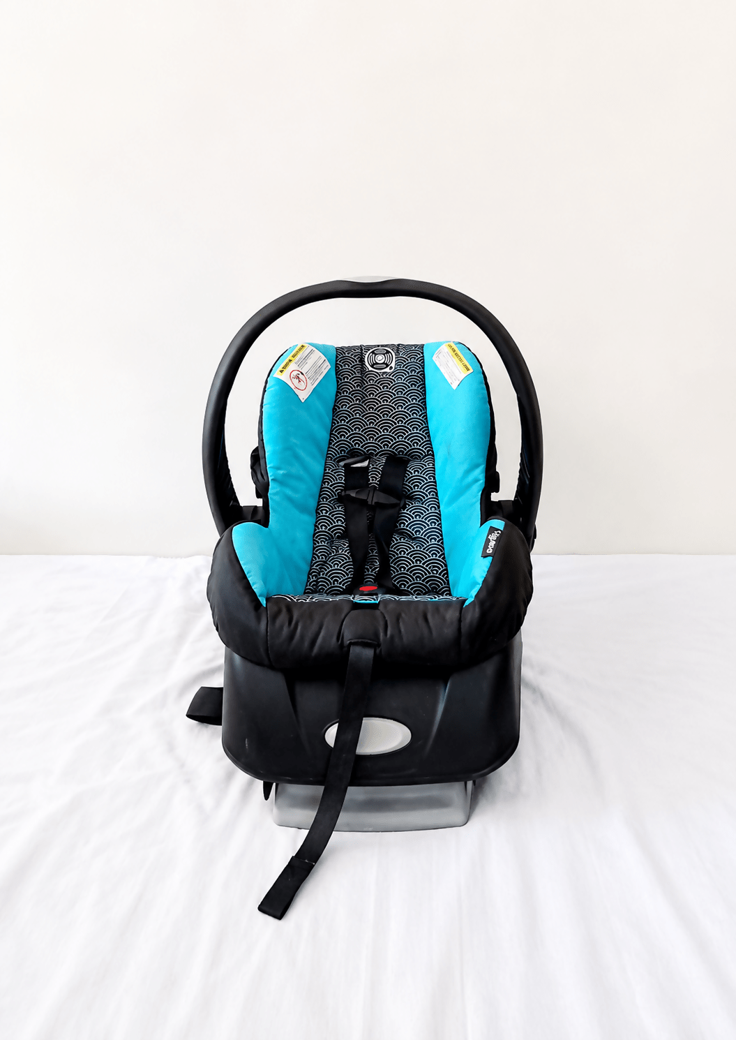 Evenflo Embrace infant car seat with base, rear-facing design, cushioned newborn support, secure safety harness, and portable baby carrier functionality for safe travel.