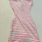 Striped dress with red and white pattern on a beige surface
