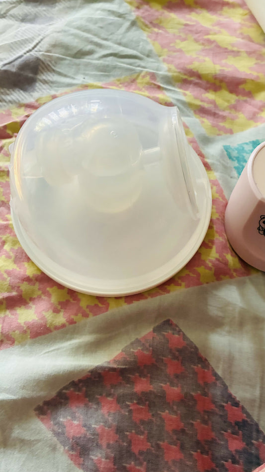 Round container with a lid on a patterned fabric background