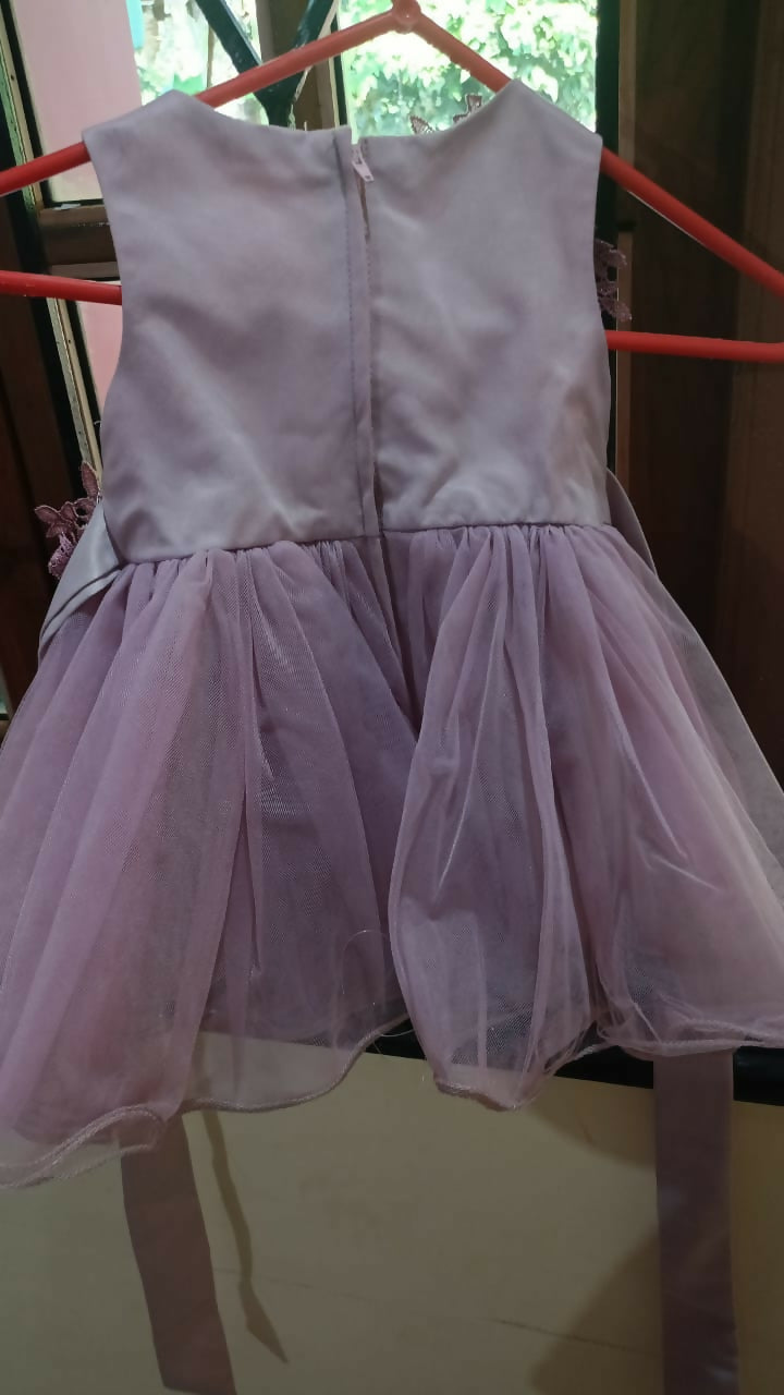Light purple dress hanging on a rack 