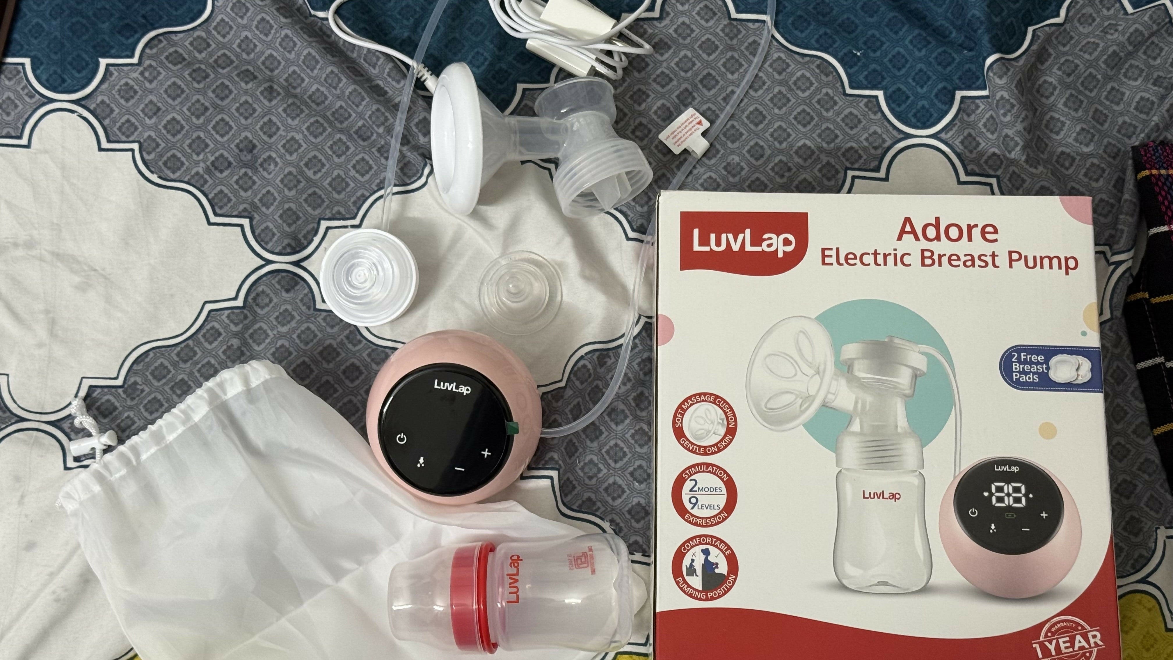 Luvlap Adore electric breast pump with packaging on a patterned surface