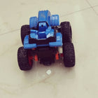 Toy car made of blue and black blocks on a tiled floor