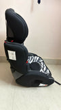 Black and gray car seat with zebra pattern on a light-colored floor.