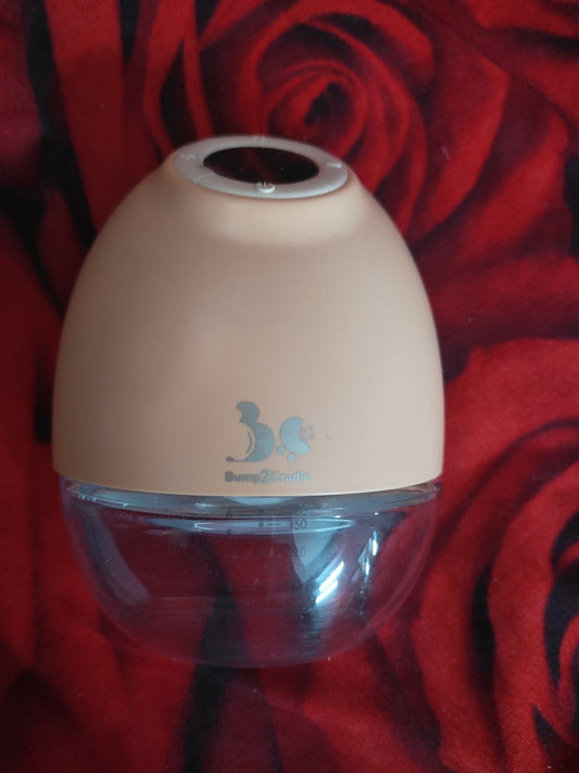 Beige humidifier with a clear water tank on a red floral background