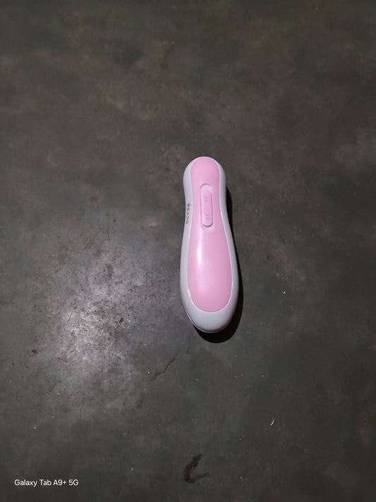 Pink and white electronic device on a dark surface