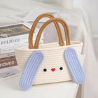 Woven handbag with bunny ears and face on a white surface