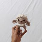 Handmade crochet rattle for babies with soft yarn construction, easy-to-hold design, gentle rattling sound, and baby-friendly craftsmanship for sensory play and development.