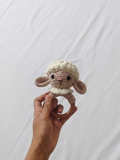Handmade crochet rattle for babies with soft yarn construction, easy-to-hold design, gentle rattling sound, and baby-friendly craftsmanship for sensory play and development.