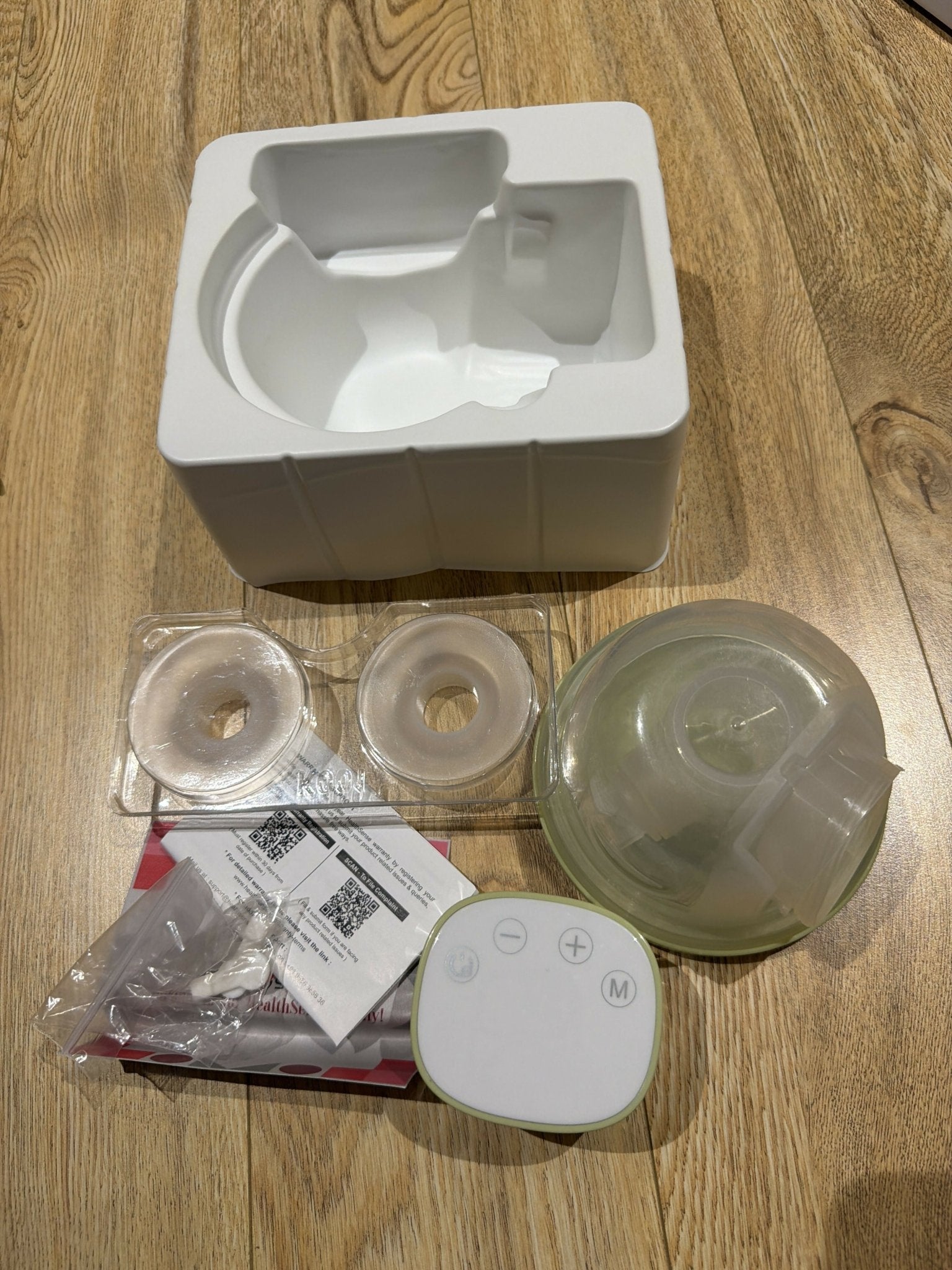 HealthSense Wearable Breast Pump with 3 pumping modes, hands-free wearable design, adjustable suction levels, rechargeable battery, quiet operation, leak-resistant collection cups, and BPA-free components.