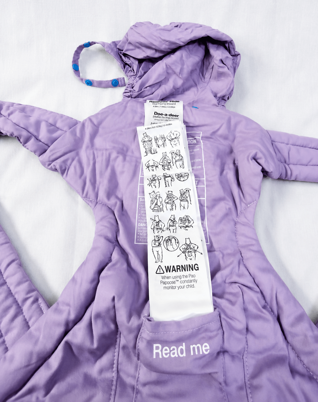 We Made Me Pao Papoose Three 3-in-1 Baby Carrier in Purple with multiple carrying positions, padded shoulder straps, adjustable waist belt, ergonomic support, and breathable fabric for comfortable babywearing.