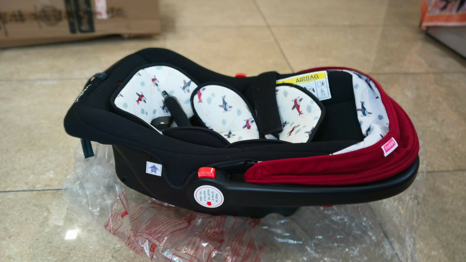 Babyhug Amber Car Seat Cum Carry Cot with padded seating, secure safety harness, ergonomic carry handle, protective canopy, and versatile design for comfortable travel with newborns and infants.