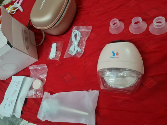Baby bottle sterilizer and accessories on a red surface
