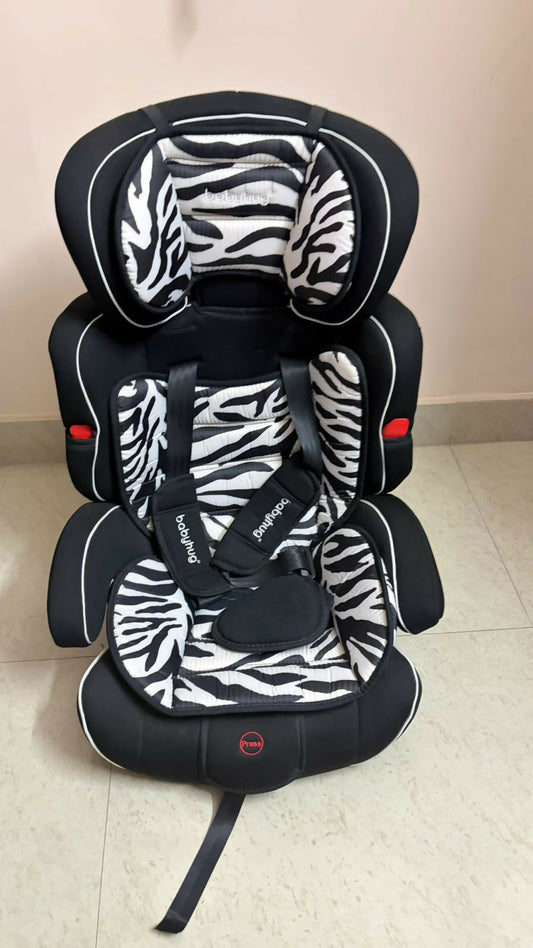 Zebra-patterned car seat on a beige floor