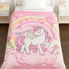 Pink unicorn-themed comforter on a bed i