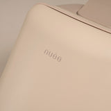 Beige product with 'nué' branding on a beige background