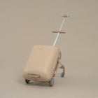 Beige suitcase with wheels and handle on a beige background