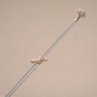 Light gray metal rod with beige rubber ends on a beige background