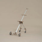 Three-wheeled scooter with a stand on a beige background