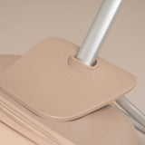Beige suitcase with a handle on a beige background