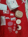 Breast pump parts and accessories on a red surface