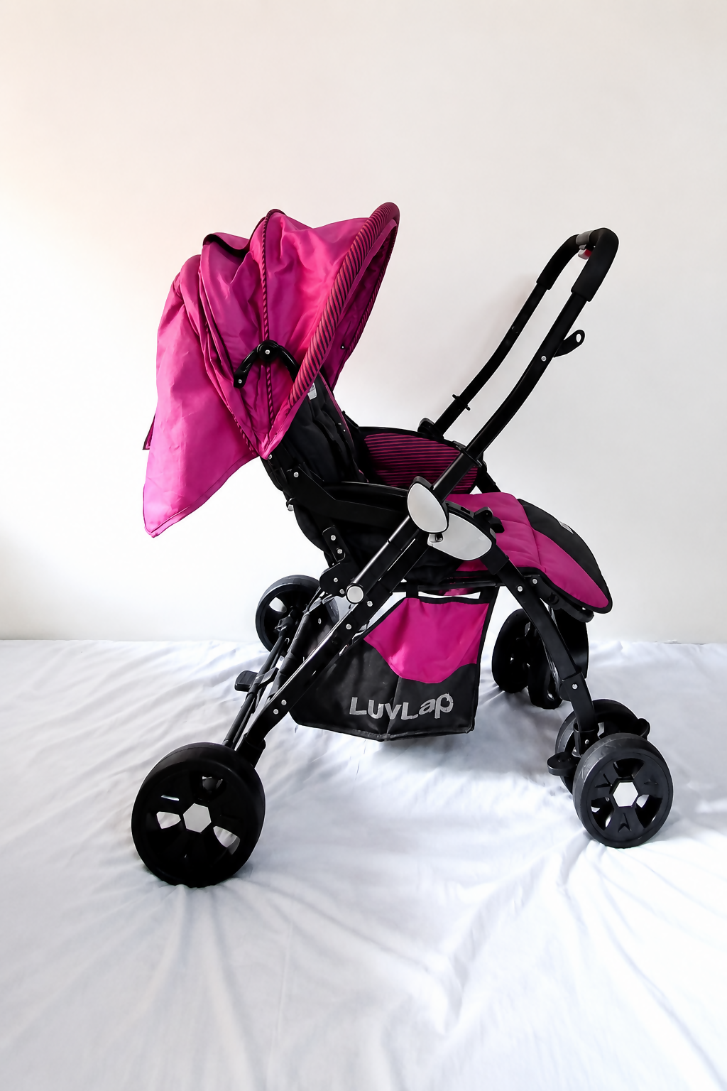 LUVLAP Galaxy reversible baby stroller in pink and black with foldable travel pram design, adjustable seat, canopy, and sturdy wheels for comfortable baby travel