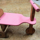 Pink wooden kids balance bike with handlebar and single front wheel, pink, brown