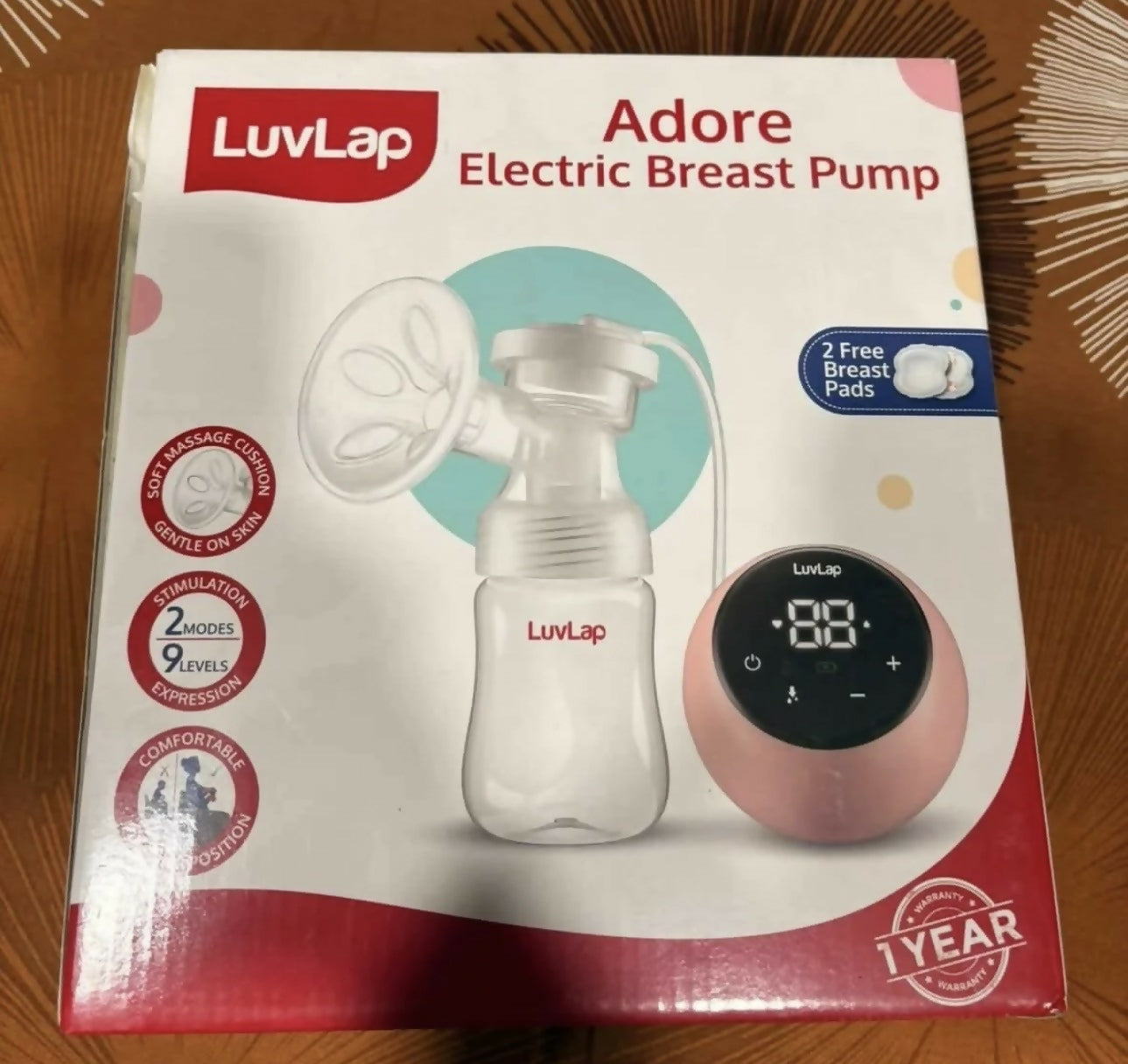 LuvLap Adore Electric Breast Pump with adjustable suction levels, multiple pumping modes, soft silicone breast cushion, compact design, and easy-to-use controls for comfortable and convenient milk expression.
