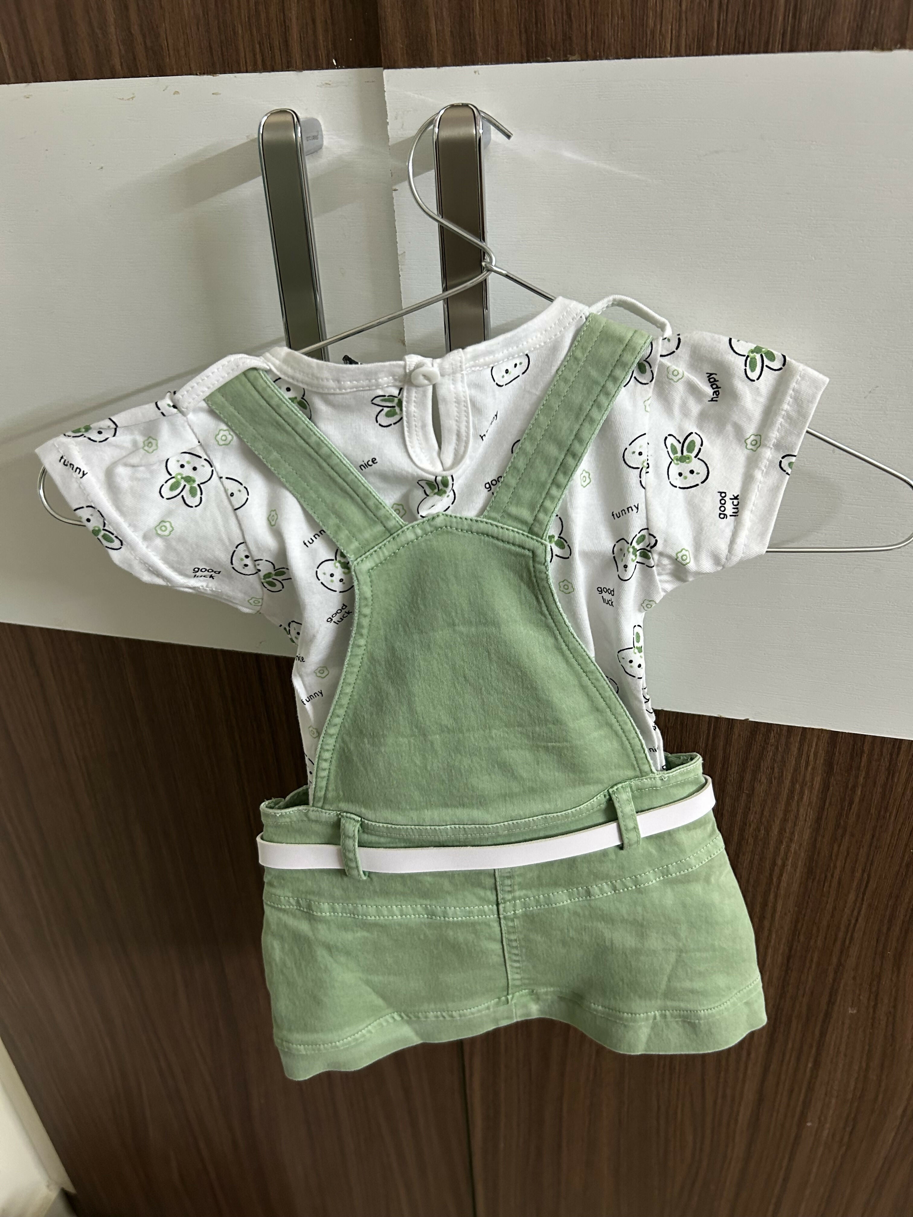 Children's outfit with white shirt and green overalls 