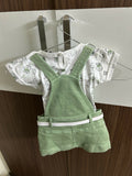 Children's outfit with white shirt and green overalls 