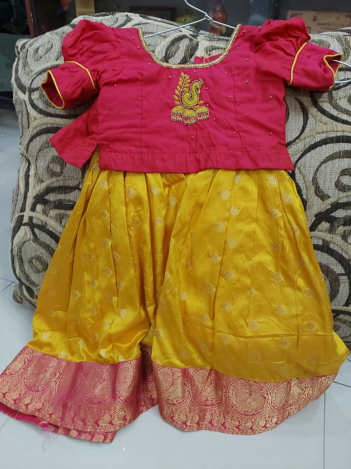 Red and yellow traditional outfit with intricate designs 