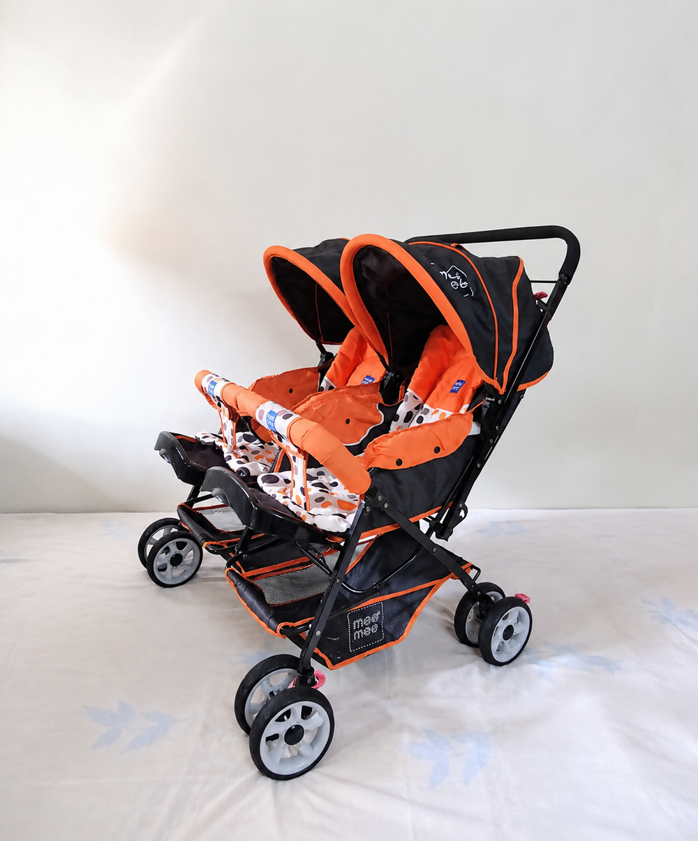 MEE MEE Twin Baby Stroller/Double Pram in Orange, Some Used condition, featuring two seats, reclining design, protective canopies and a foldable frame for convenient outings with twins or two young children.