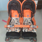 Mee Mee twin stroller pram for babies with dual seating, safety harnesses, smooth wheels, adjustable canopies, and comfortable design for outings with two children.