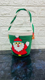 Green woven basket with a Santa Claus design
