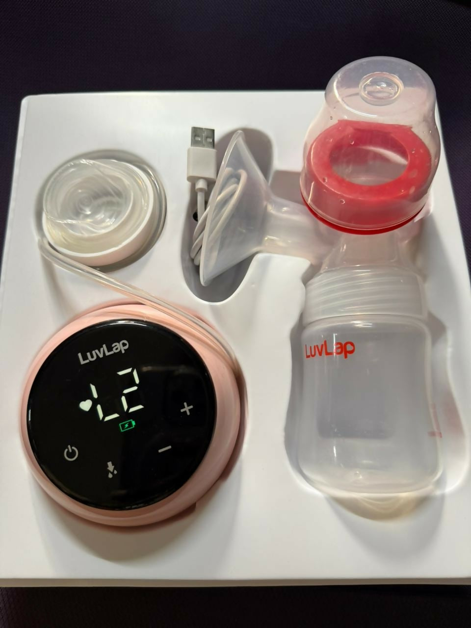 LuvLap breast pump set with digital display and USB cable on a white background