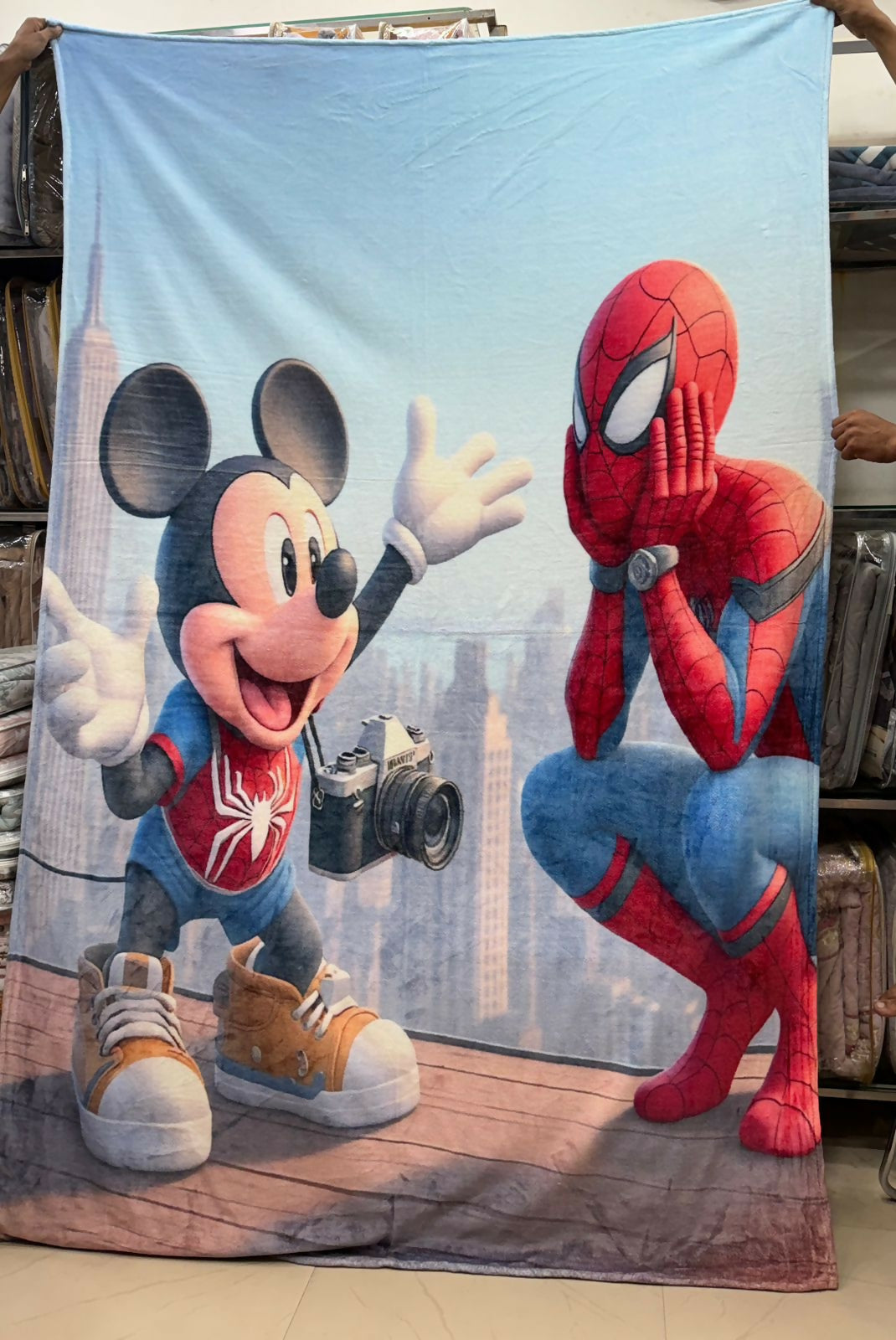 Blanket with cartoon characters resembling Mickey Mouse and Spider-Man in superhero costumes.