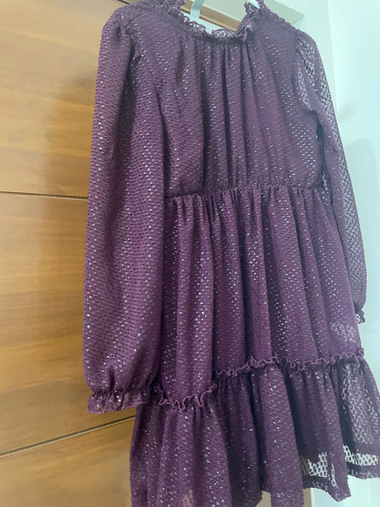 Purple dress with a pattern on a wooden floor