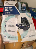 R for Rabbit Cozy Carry Cot/Car Seat with rear-facing design, cushioned seating, ergonomic carry handle, 5-point safety harness, and protective canopy for safe and comfortable travel with newborns and infants.