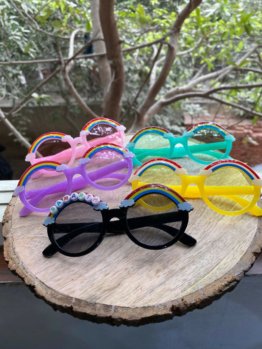 Colorful sunglasses with decorative elements on a wooden surface