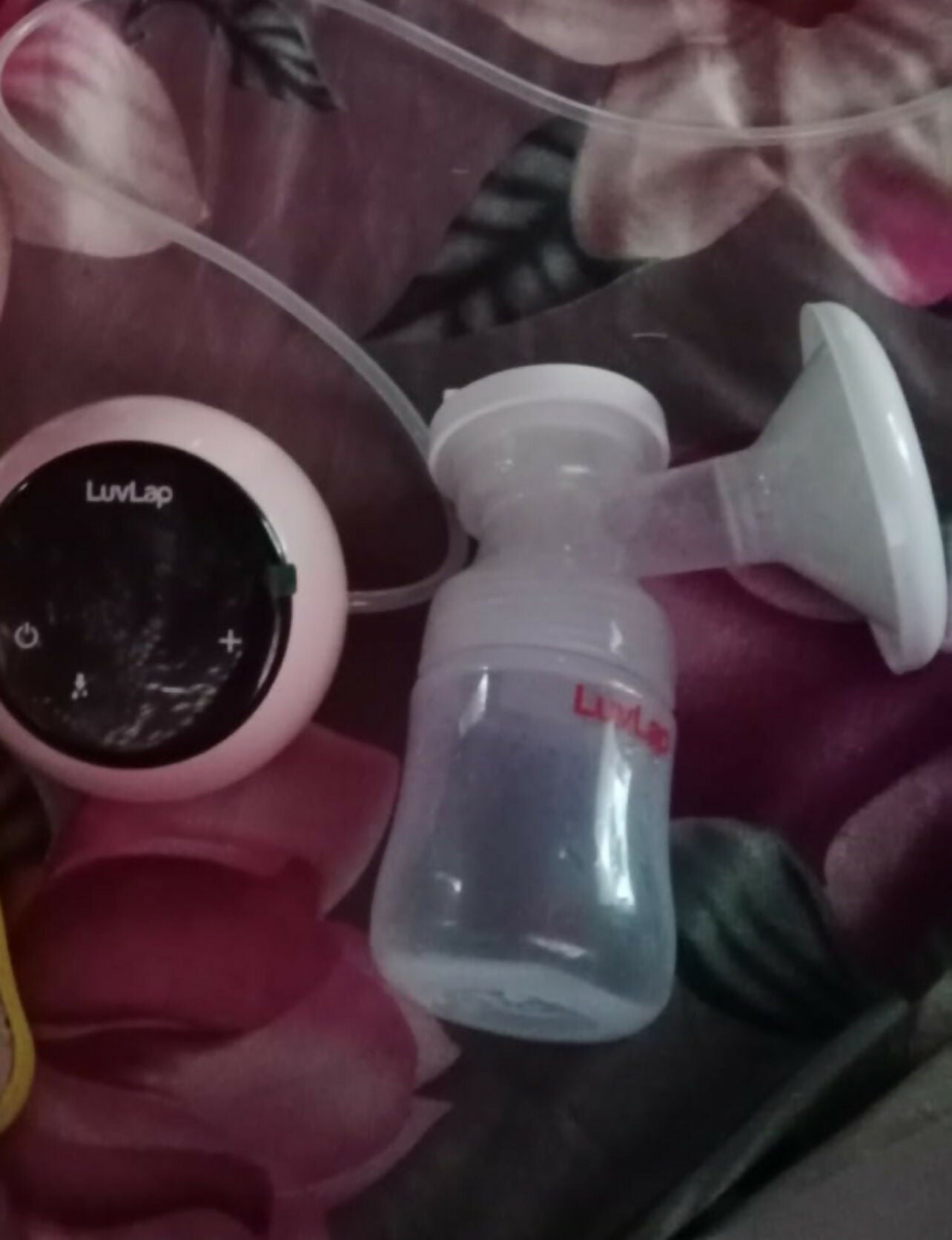 LuvLap breast pump and digital display on a pink floral background