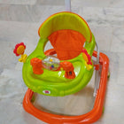 Children's walker with orange and green colors on a tiled floor