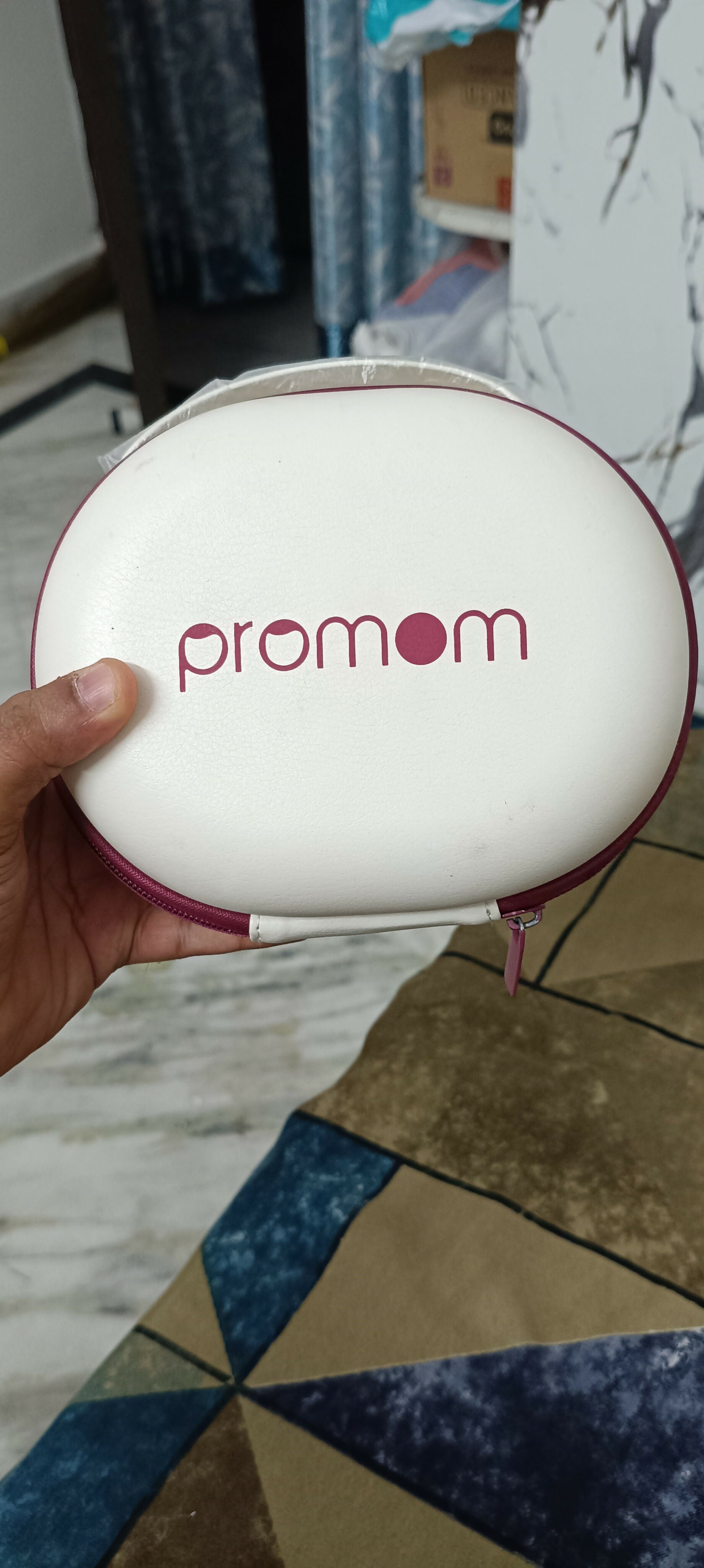 PROMOM electric wearable breast pump with hard case, hands-free design, compact milk collection cups, adjustable suction, and portable pumping support for breastfeeding mothers.