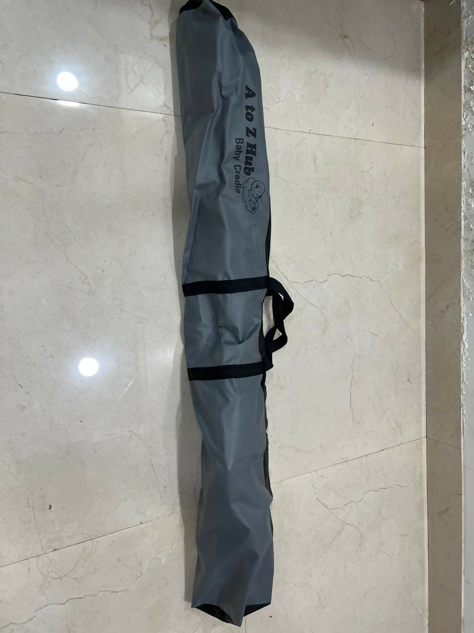 A TO Z HUB portable folding Ghodiyu traditional baby cradle with black cotton cloth, foldable metal frame, gentle rocking design, and a comfortable sleeping space for newborns and infants.