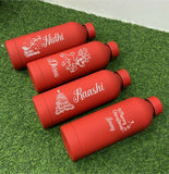 Four red water bottles with personalized names 