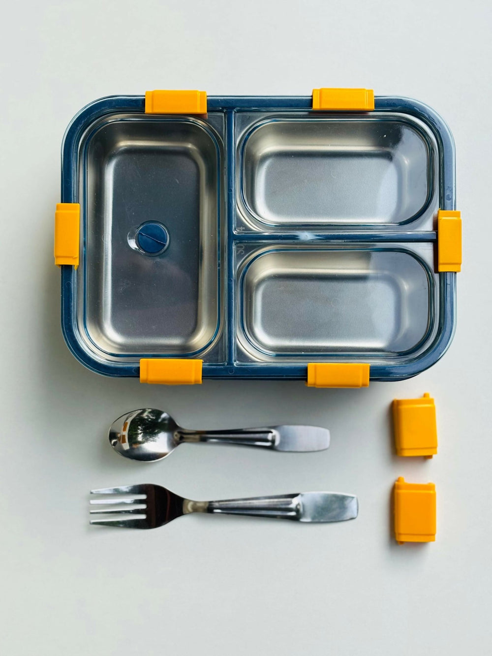 Stainless steel lunch box with compartments, spoon, and fork 