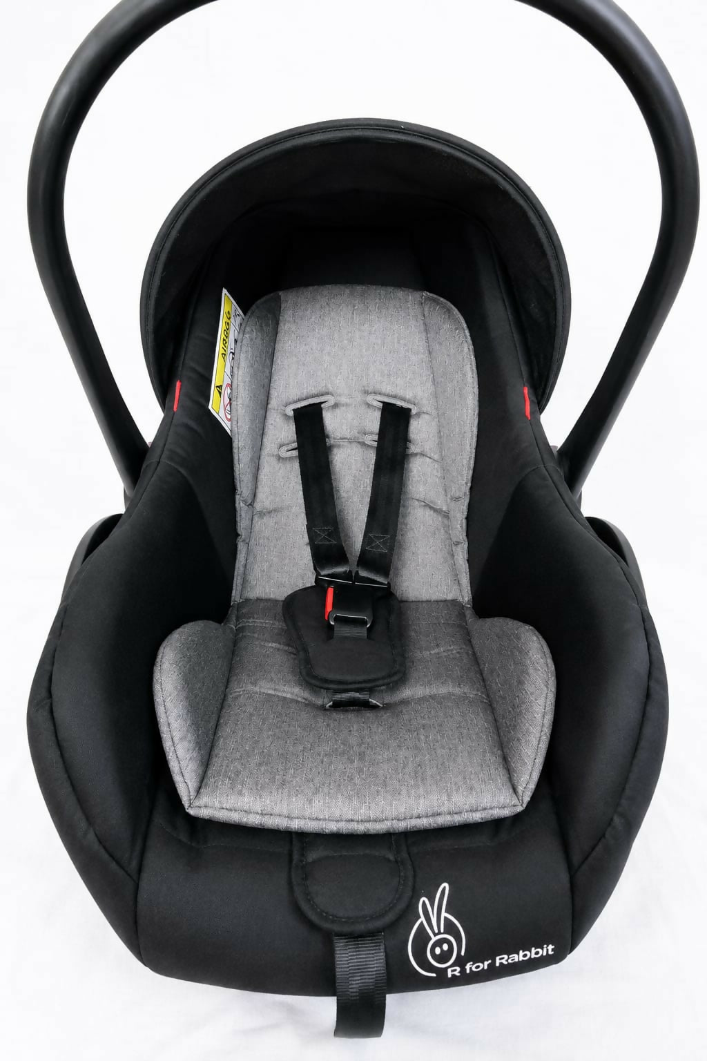 R for Rabbit Picaboo Grand 4 in 1 infant car seat carrier in black and grey with newborn travel cot design, cushioned seat, safety harness, carry handle, and secure support for baby travel.