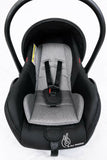 R for Rabbit Picaboo Grand 4 in 1 infant car seat carrier in black and grey with newborn travel cot design, cushioned seat, safety harness, carry handle, and secure support for baby travel.